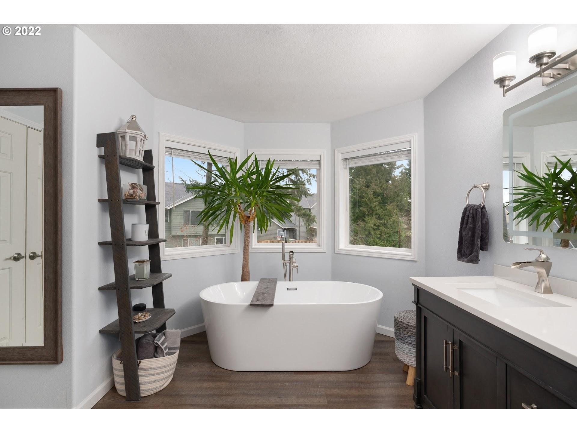 16625 Southwest Springwater Court Beaverton, OR 97006 - Photo 22 of 32 a view of a bathtub in a room with a potted plant
