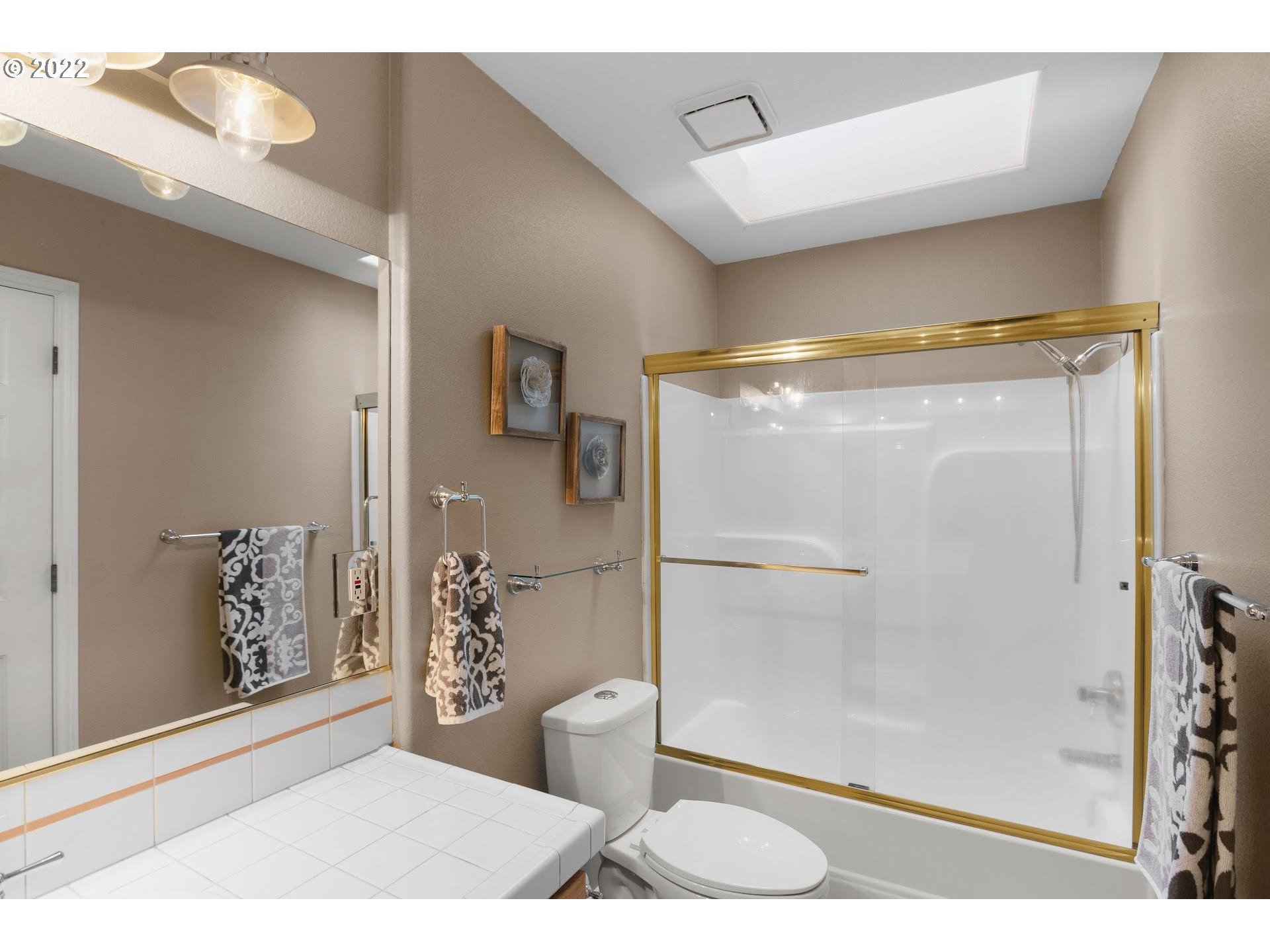 16625 Southwest Springwater Court Beaverton, OR 97006 - Photo 27 of 32 a view of bathroom with a shower and toilet