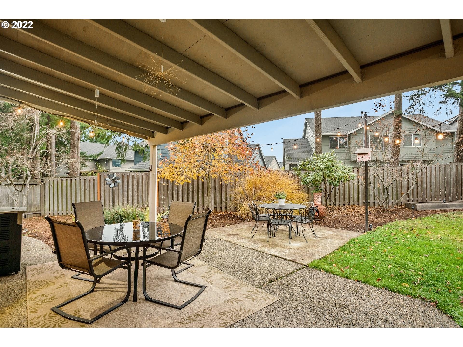 16625 Southwest Springwater Court Beaverton, OR 97006 - Photo 30 of 32 a view of a patio with table and chairs and potted plants