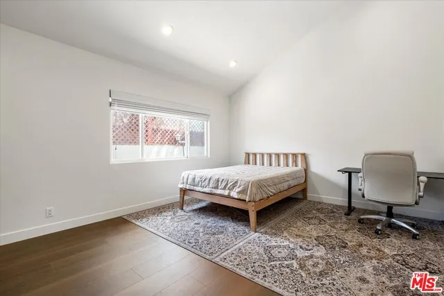a bedroom with a bed chair and window