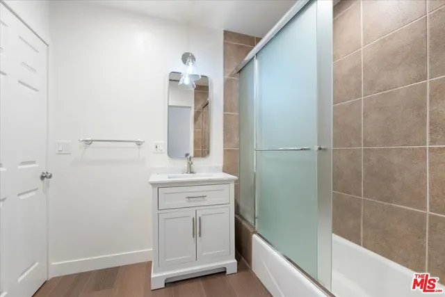 a bathroom with a shower and a sink