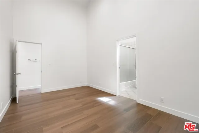 an empty room with wooden floor and closet