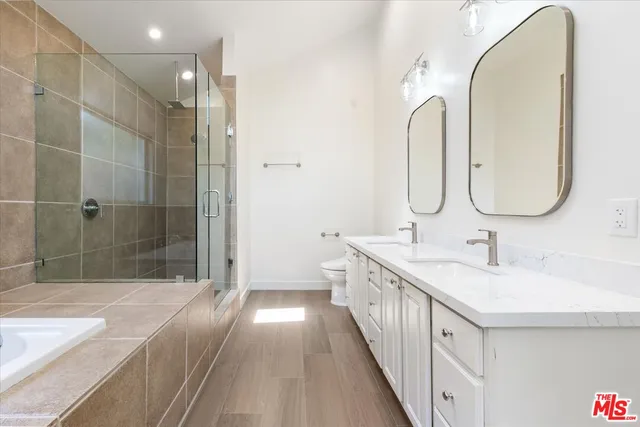 a bathroom with a double vanity sink and mirror with shower