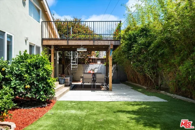 a view of a chairs and table in backyard of the house