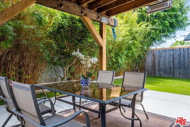a view of backyard with seating and green space