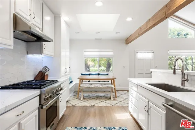 a kitchen with a sink stove and cabinets