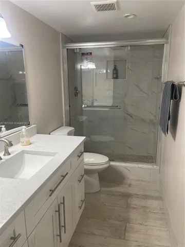 a bathroom with a shower and a toilet