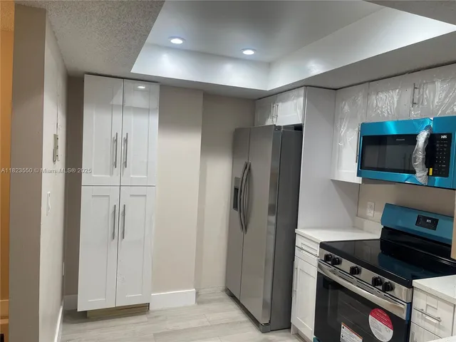 a kitchen with a stove a sink and a microwave