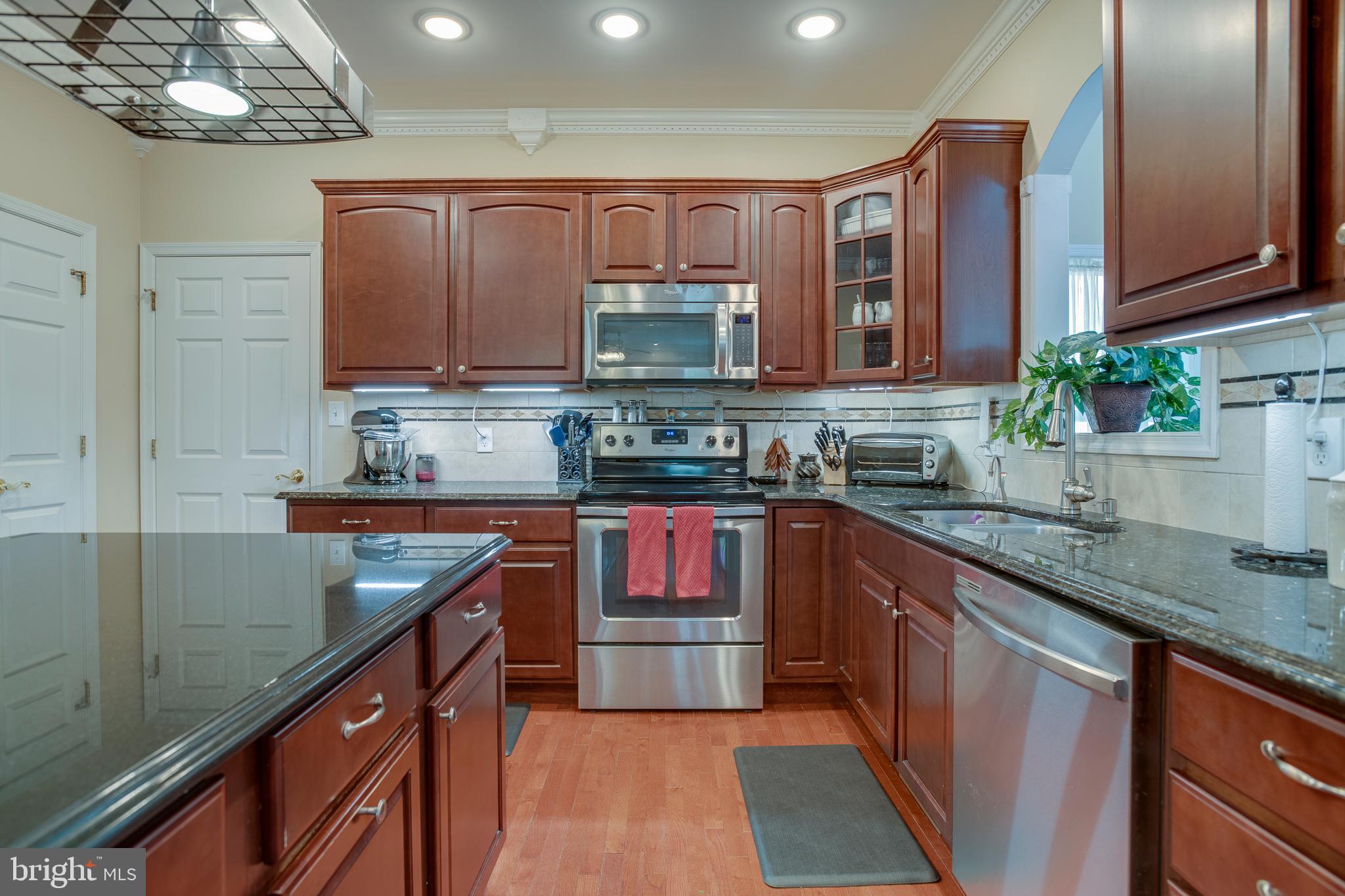 101 Saylers Creek Road Locust Grove, VA 22508 - Photo 12 of 81 a kitchen with stainless steel appliances granite countertop a sink stove and cabinets