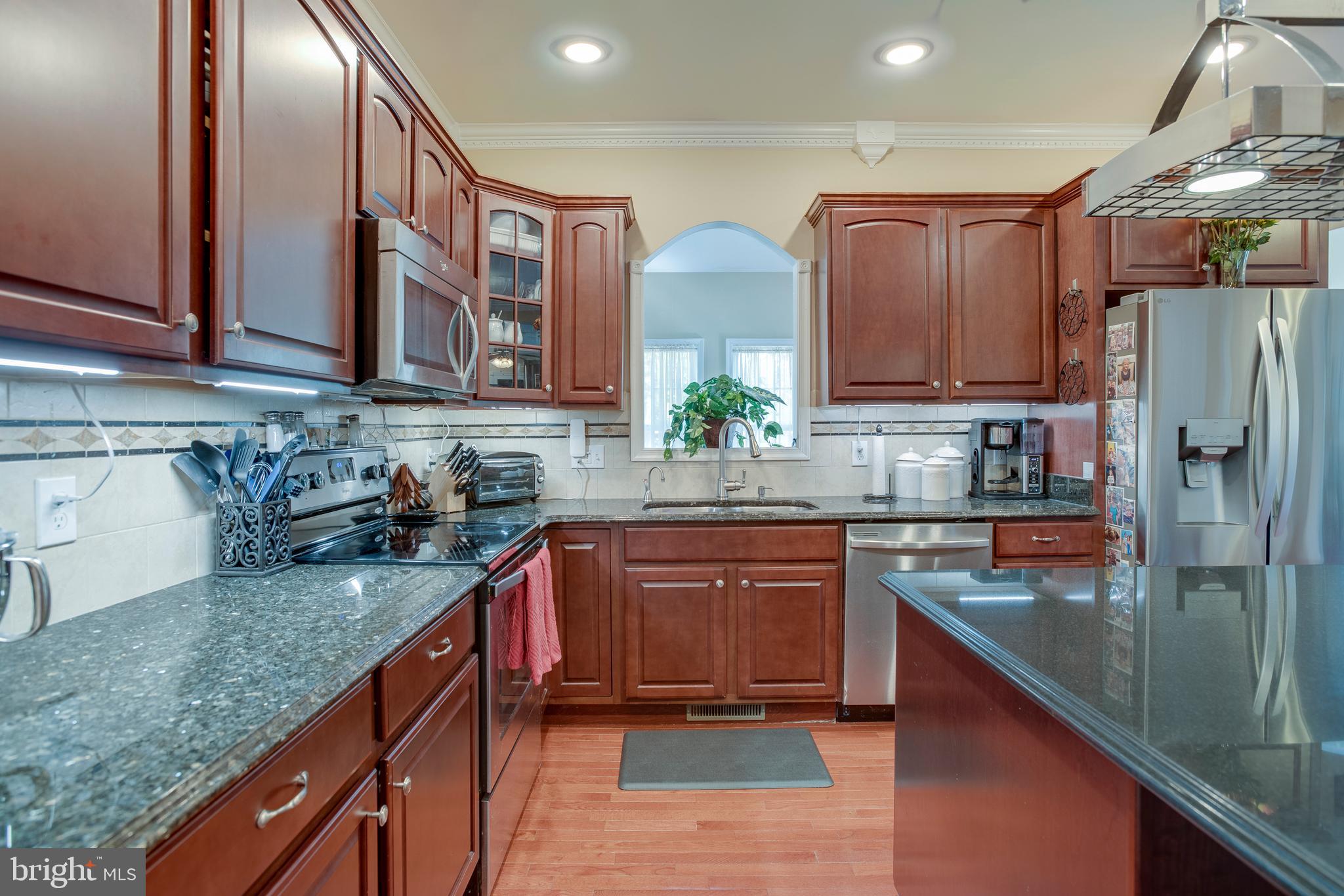 101 Saylers Creek Road Locust Grove, VA 22508 - Photo 13 of 81 a kitchen with stainless steel appliances granite countertop a sink stove and refrigerator