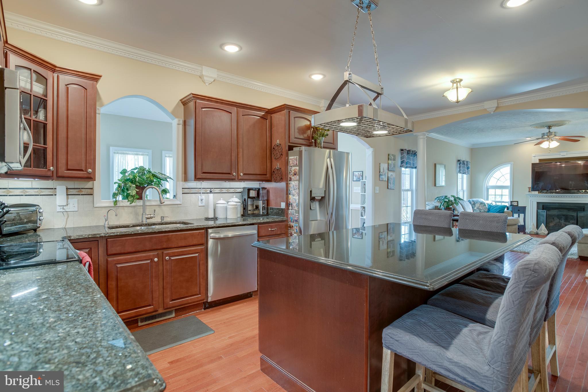 101 Saylers Creek Road Locust Grove, VA 22508 - Photo 14 of 81 a kitchen with stainless steel appliances granite countertop a sink refrigerator and cabinets