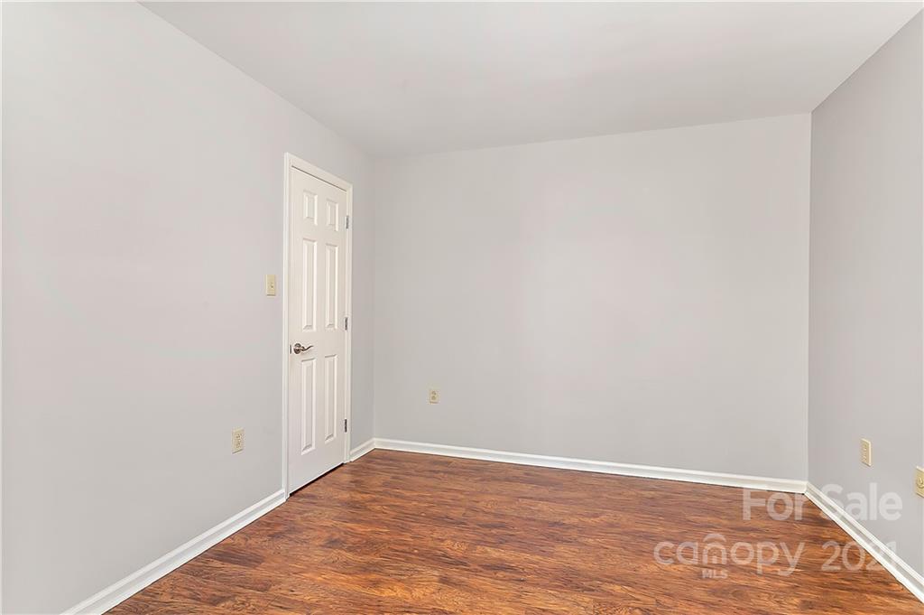 5011 Sharon Road, Unit E Charlotte, NC 28210 - Photo 13 of 19 a view of an empty room with wooden floor