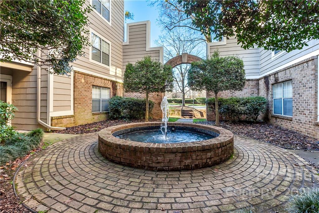 5011 Sharon Road, Unit E Charlotte, NC 28210 - Photo 17 of 19 a view of a house with backyard and sitting area
