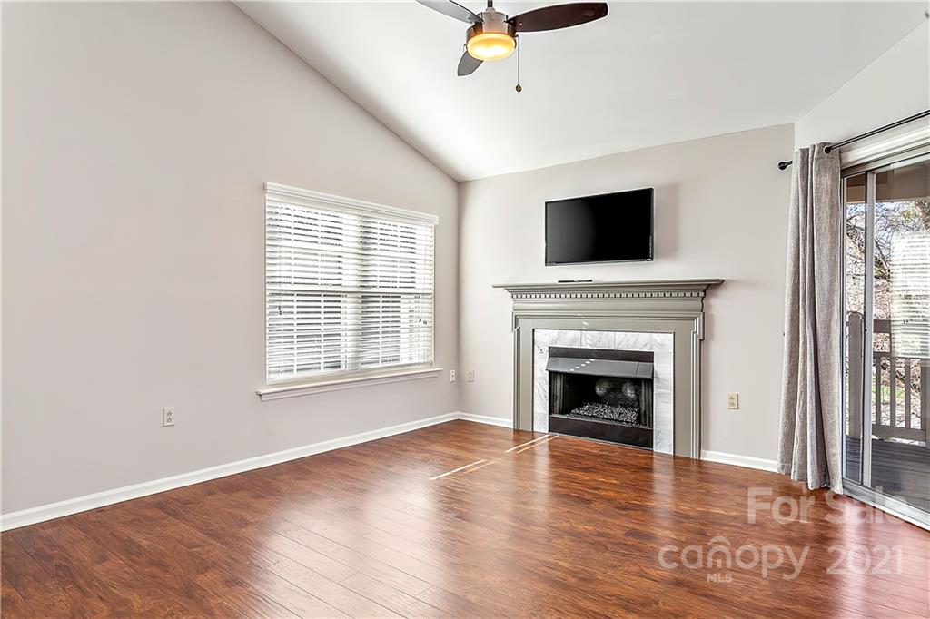 5011 Sharon Road, Unit E Charlotte, NC 28210 - Photo 3 of 19 a living room with wooden floor and a fireplace