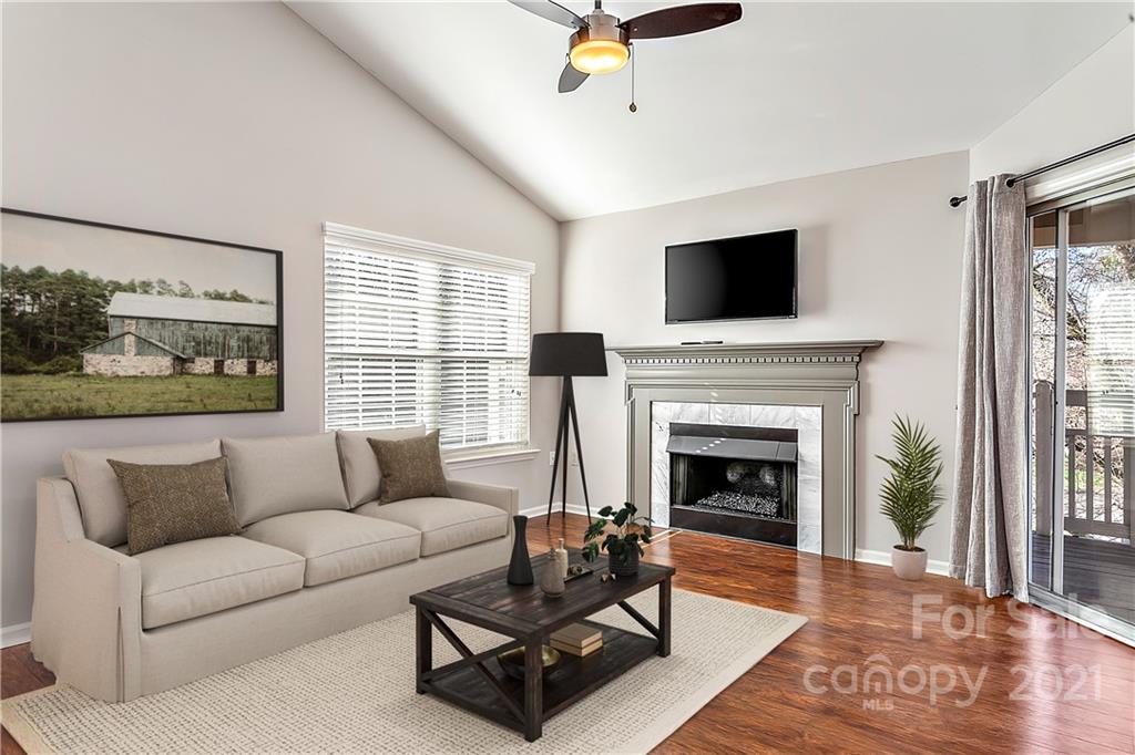 5011 Sharon Road, Unit E Charlotte, NC 28210 - Photo 4 of 19 a living room with furniture a flat screen tv and a fireplace