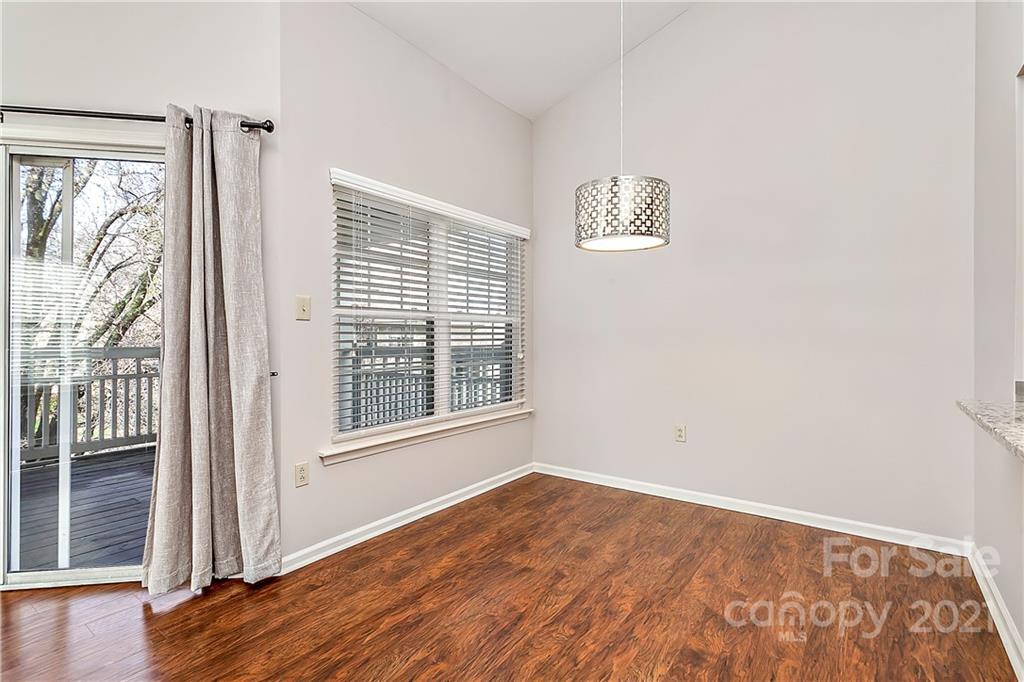 5011 Sharon Road, Unit E Charlotte, NC 28210 - Photo 5 of 19 an empty room with a window and wooden floor