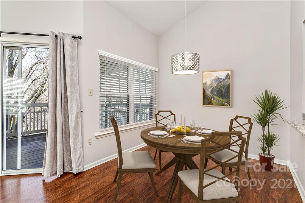5011 Sharon Road, Unit E Charlotte, NC 28210 - Photo 6 of 19 a view of a dining room with furniture window and wooden floor