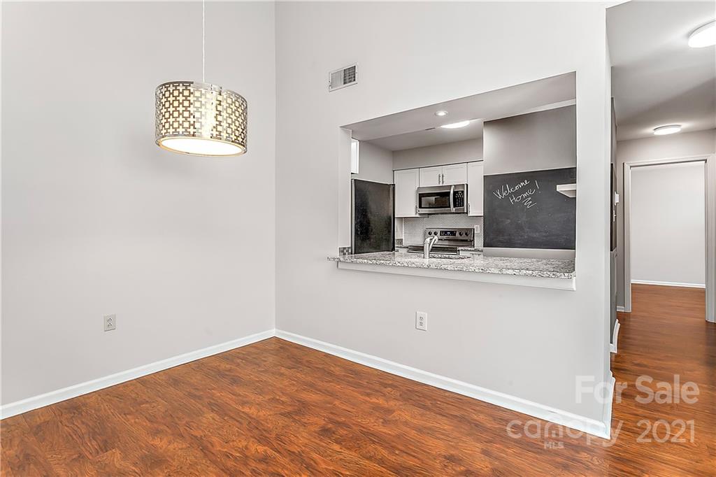 5011 Sharon Road, Unit E Charlotte, NC 28210 - Photo 7 of 19 a view of kitchen with granite countertop cabinets and refrigerator