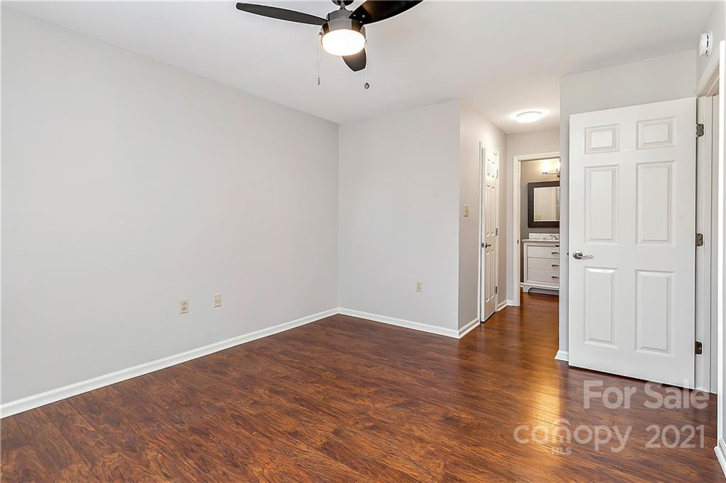 5011 Sharon Road, Unit E Charlotte, NC 28210 - Photo 9 of 19 an empty room with wooden floor