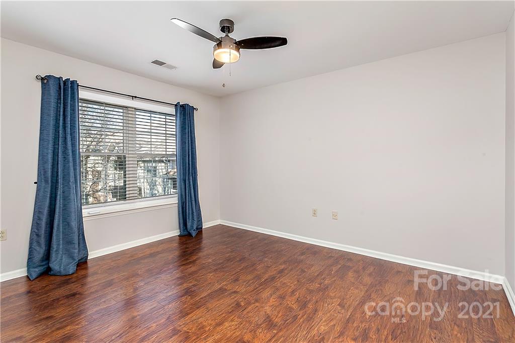 5011 Sharon Road, Unit E Charlotte, NC 28210 - Photo 10 of 19 wooden floor in an empty room with a window