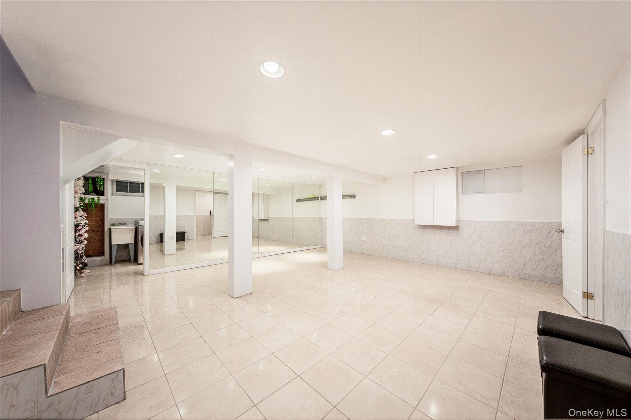 105 Seaman Road Jericho, NY 11753 - Photo 10 of 11 a view of a room with gym equipment and entryway