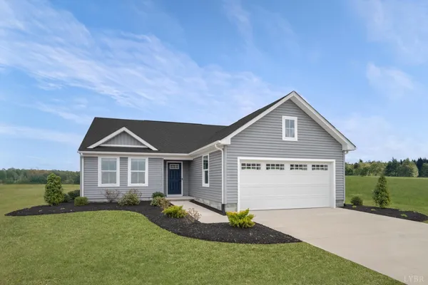 a front view of a house with a garden and yard