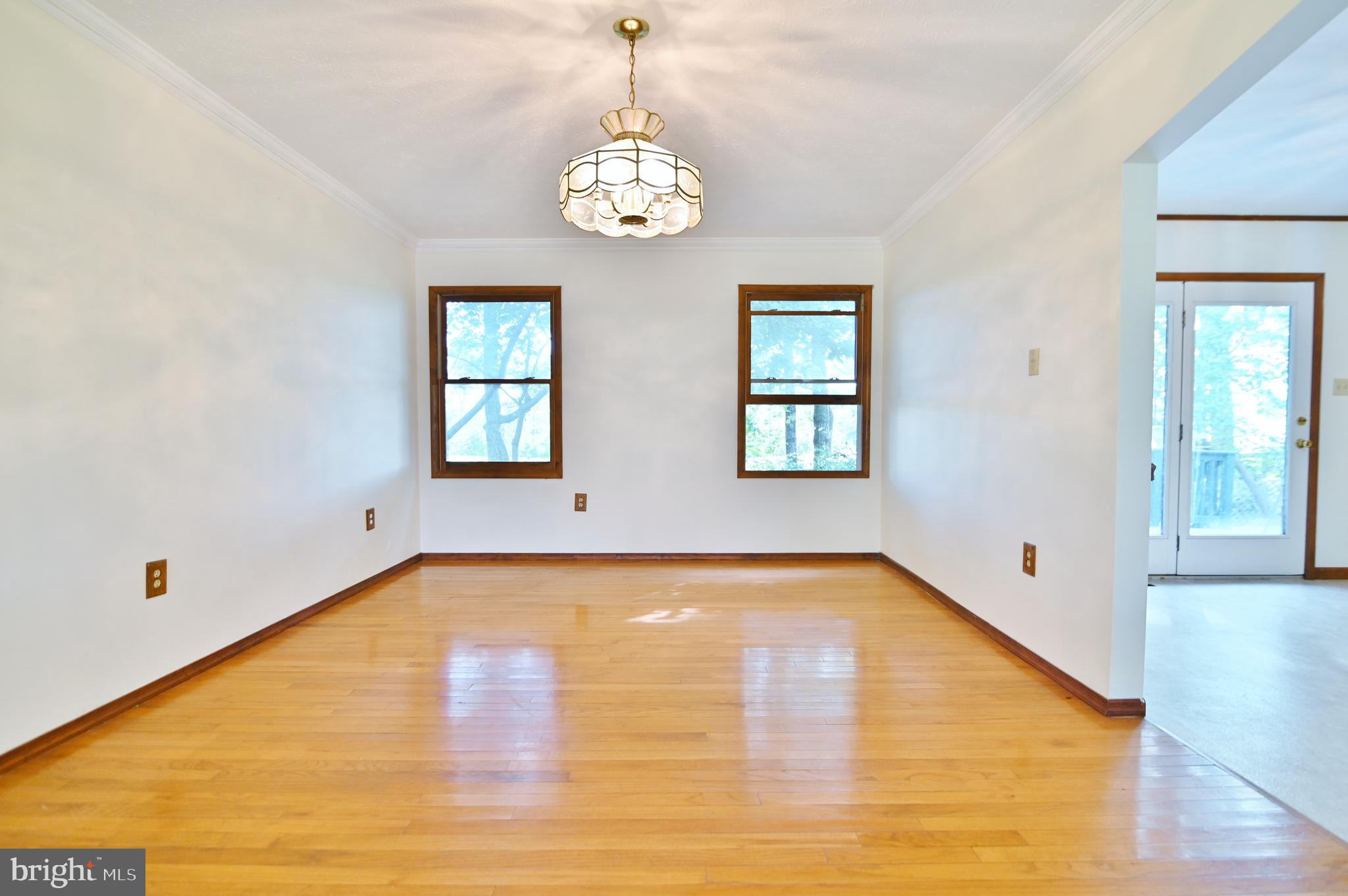 2784 Ridge Hollow Road Edinburg, VA 22824 - Photo 20 of 60 a view of a room with wooden floor and chandelier
