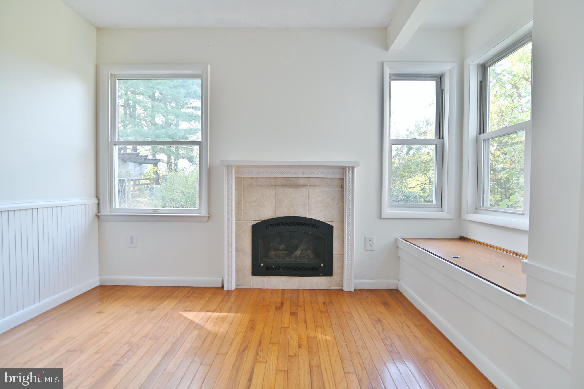 2784 Ridge Hollow Road Edinburg, VA 22824 - Photo 25 of 60 a living room with a fireplace and a floor to ceiling window