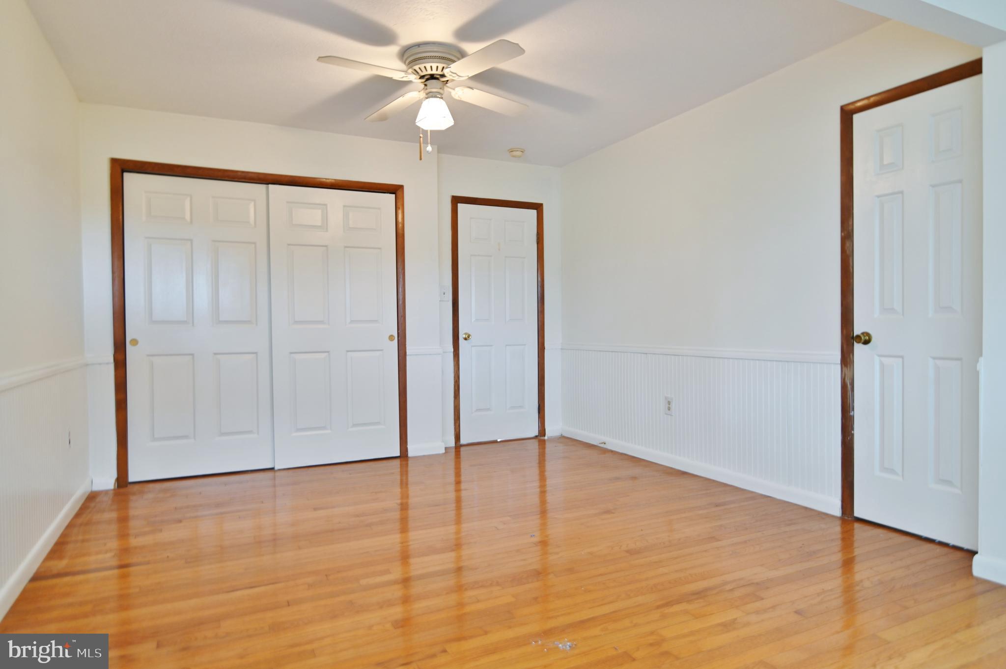 2784 Ridge Hollow Road Edinburg, VA 22824 - Photo 30 of 60 an empty room with wooden floor fan and windows