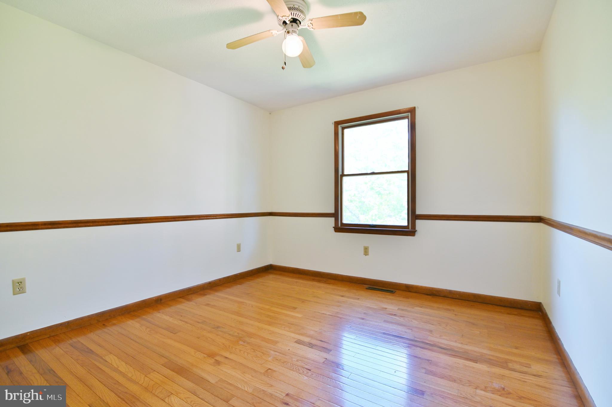 2784 Ridge Hollow Road Edinburg, VA 22824 - Photo 32 of 60 an empty room with wooden floor fan and windows
