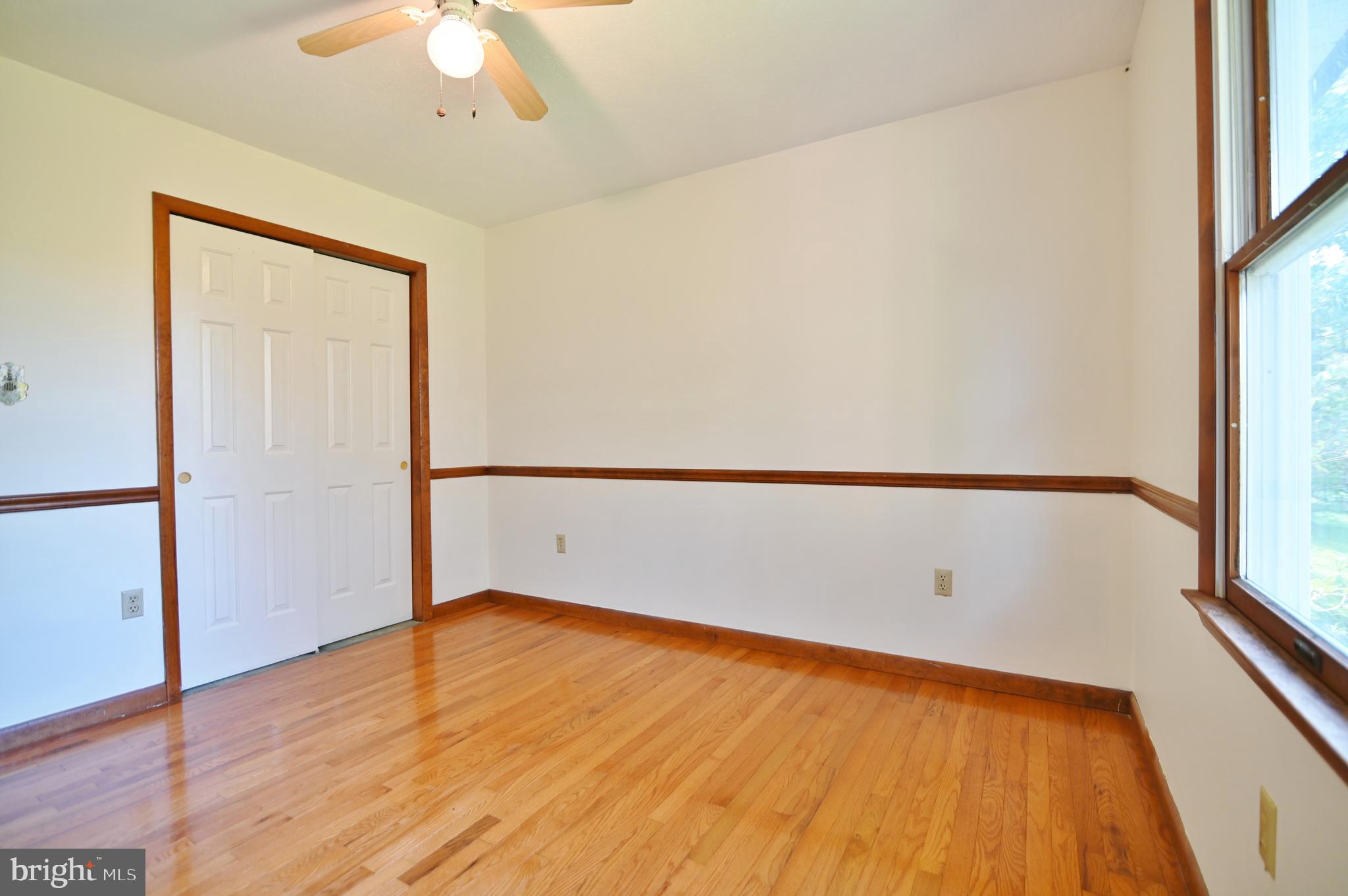 2784 Ridge Hollow Road Edinburg, VA 22824 - Photo 34 of 60 wooden floor in an empty room with a window