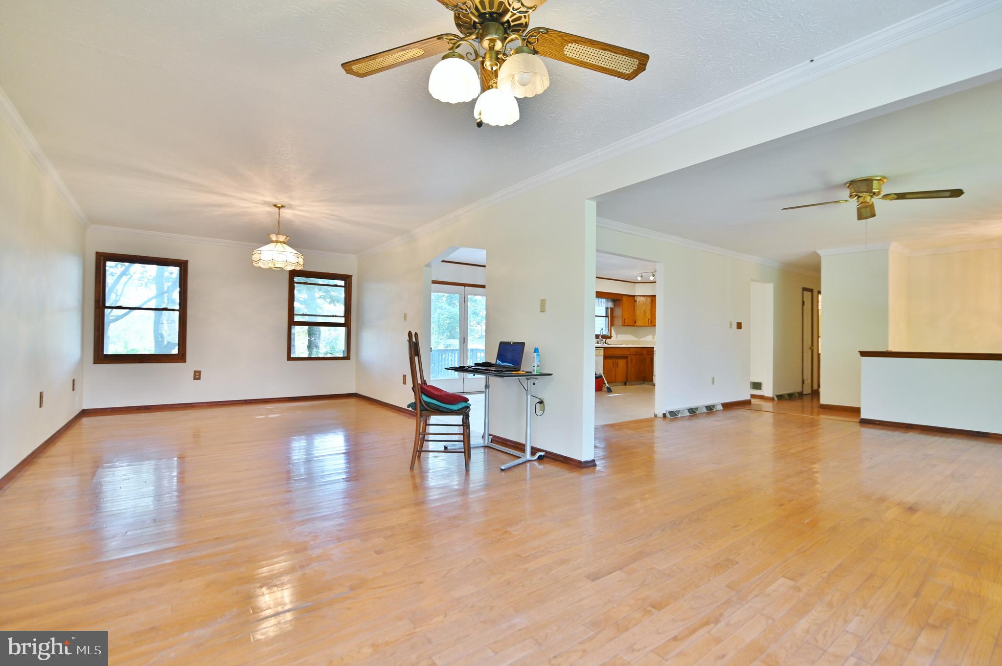 2784 Ridge Hollow Road Edinburg, VA 22824 - Photo 9 of 60 a view of an empty room with window and wooden floor