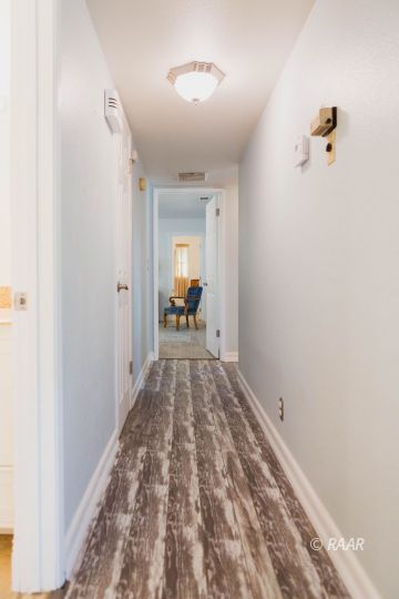 823 North Fairview Street Ridgecrest, CA 93555 - Photo 14 of 35 a view of a hallway view with wooden floor and a bathroom