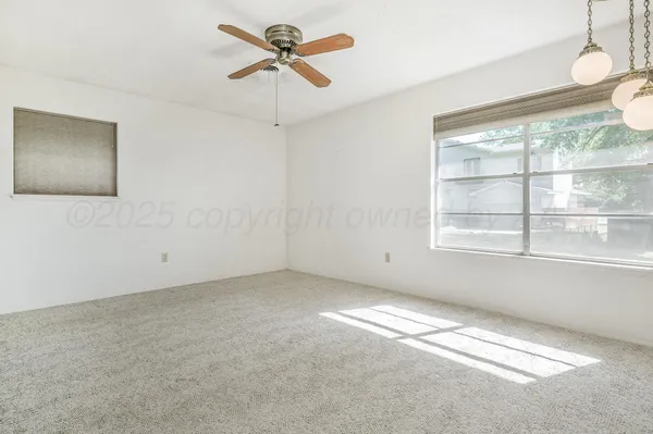 a view of an empty room with a window