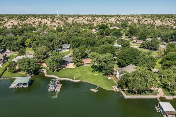 a view of a green yard with a lake view
