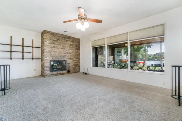 a view of an empty room with a fireplace
