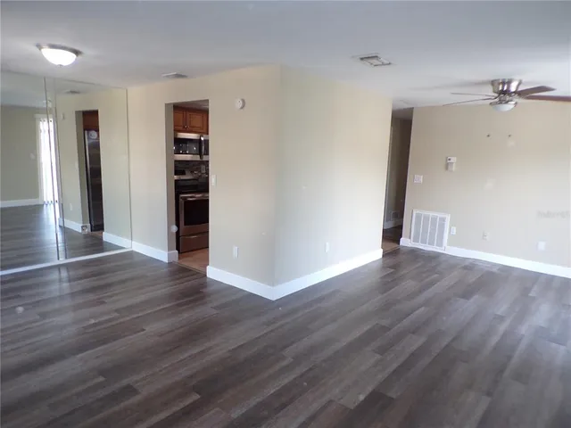 an empty room with wooden floor and closet