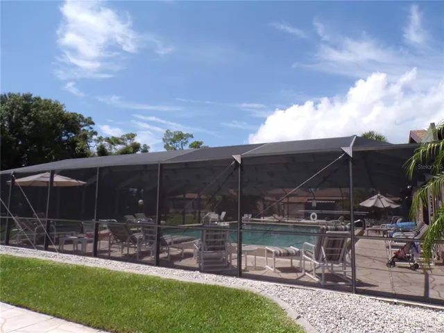 a view of house with backyard and outdoor seating