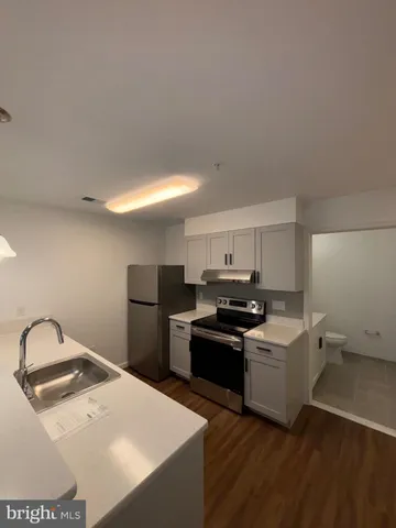 a kitchen with a sink a stove and refrigerator