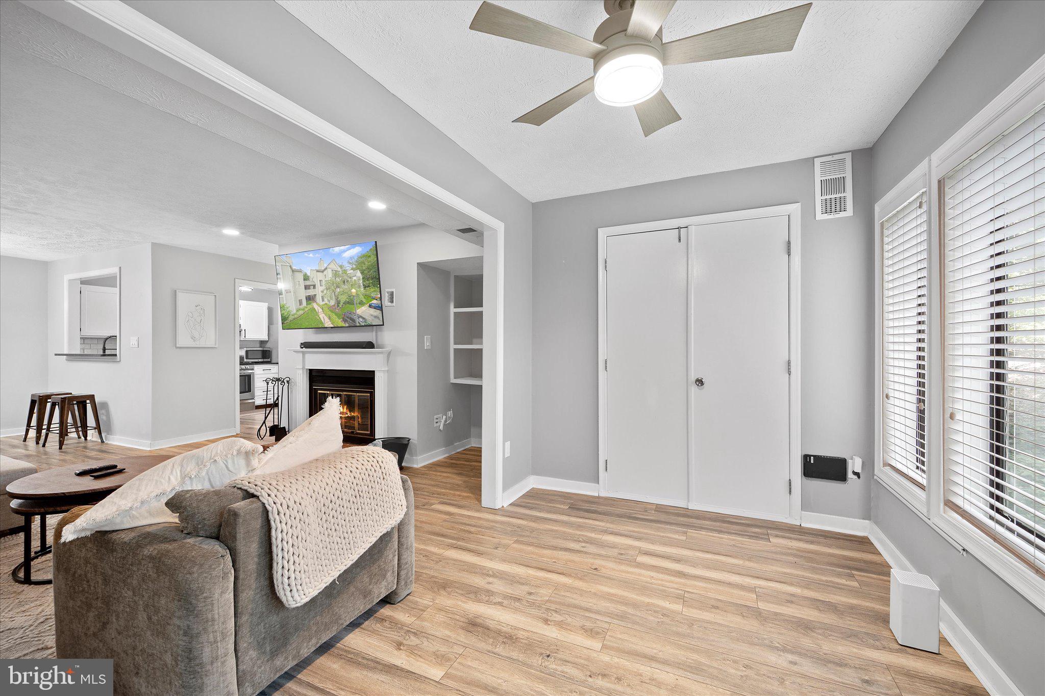 2221 Hunter's Run Drive Reston, VA 20191 - Photo 14 of 25 a living room with furniture a fireplace and a chandelier
