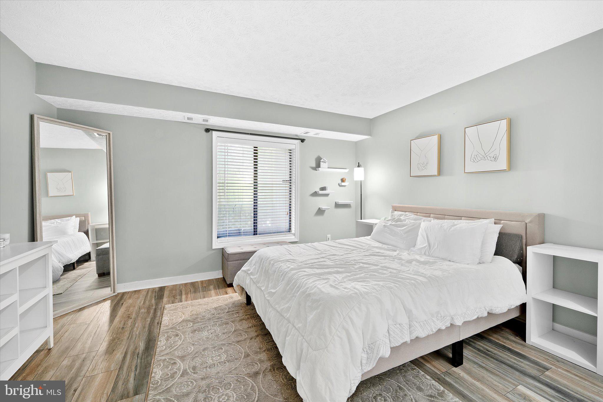 2221 Hunter's Run Drive Reston, VA 20191 - Photo 16 of 25 a large bed sitting in a bedroom and a table