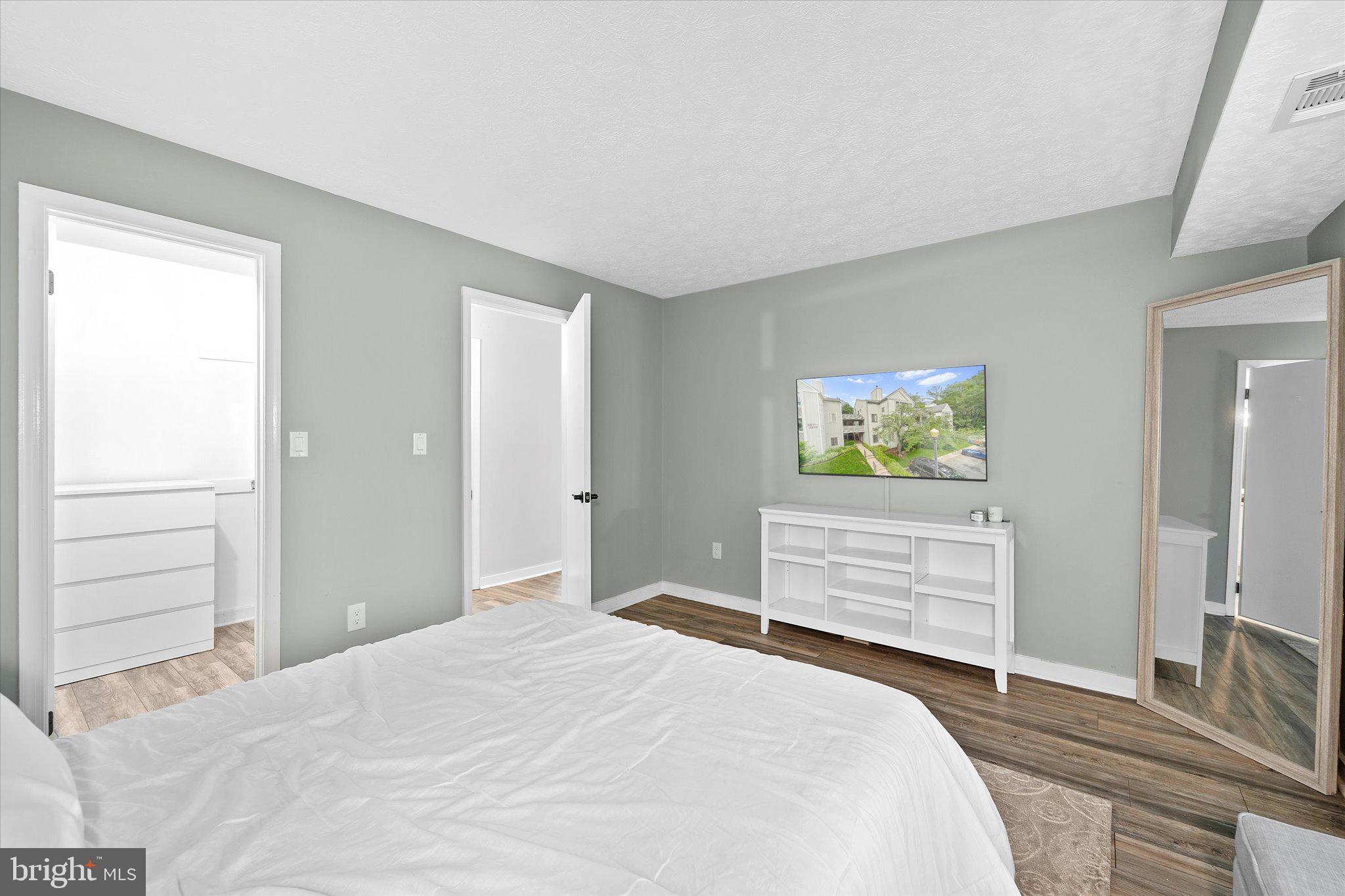 2221 Hunter's Run Drive Reston, VA 20191 - Photo 17 of 25 a bedroom with a bed and wooden floor