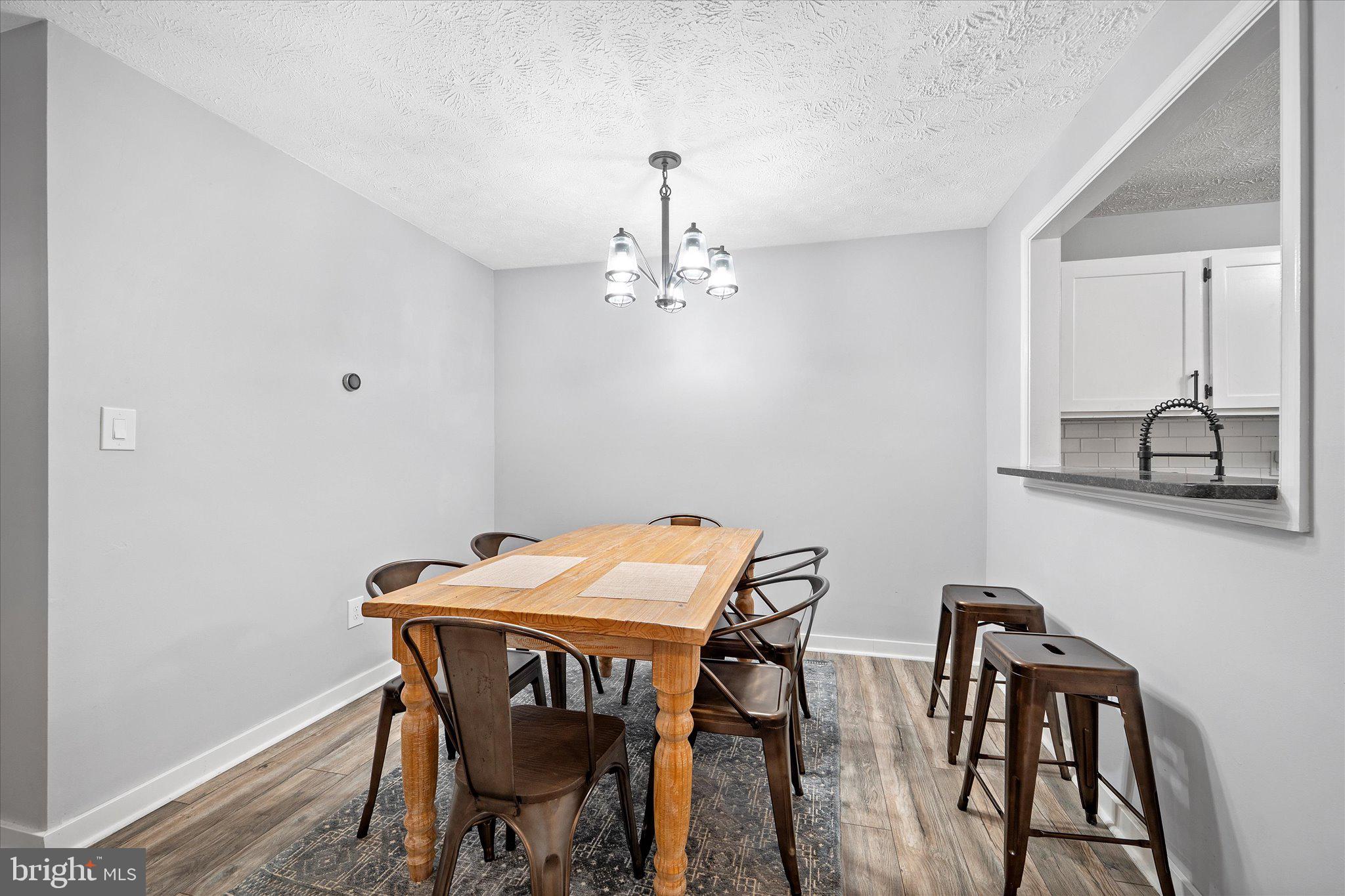 2221 Hunter's Run Drive Reston, VA 20191 - Photo 22 of 25 a view of a dining room with furniture and wooden floor