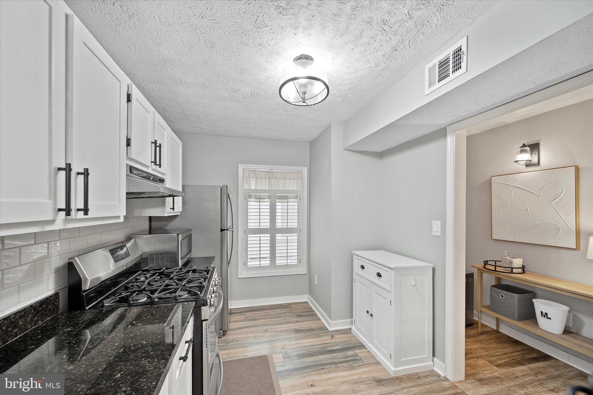 2221 Hunter's Run Drive Reston, VA 20191 - Photo 8 of 25 a view of a kitchen cabinets and a stove