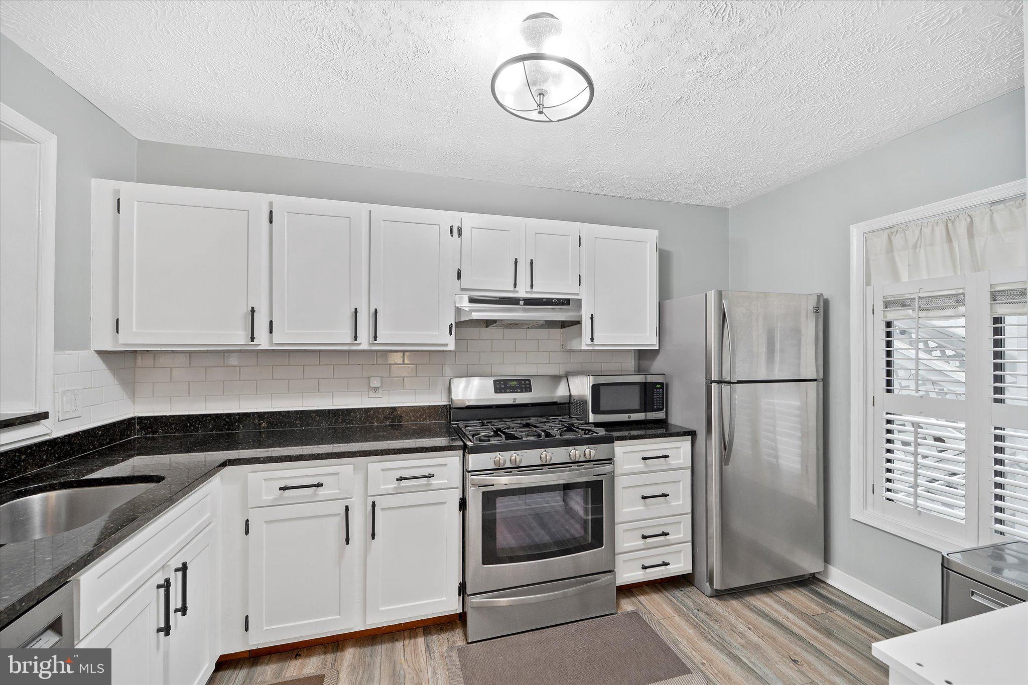 2221 Hunter's Run Drive Reston, VA 20191 - Photo 10 of 25 a kitchen with cabinets stainless steel appliances and a counter space