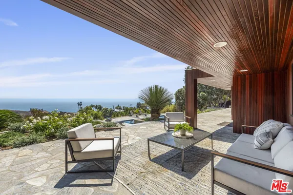 a view of a chairs and table in patio