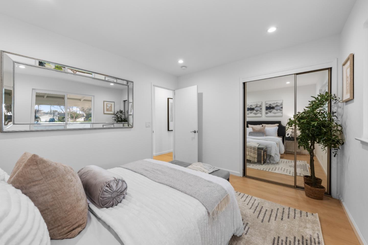 1637 Kitchener Drive Sunnyvale, CA 94087 - Photo 33 of 57 a bedroom with a large bed and a potted plant