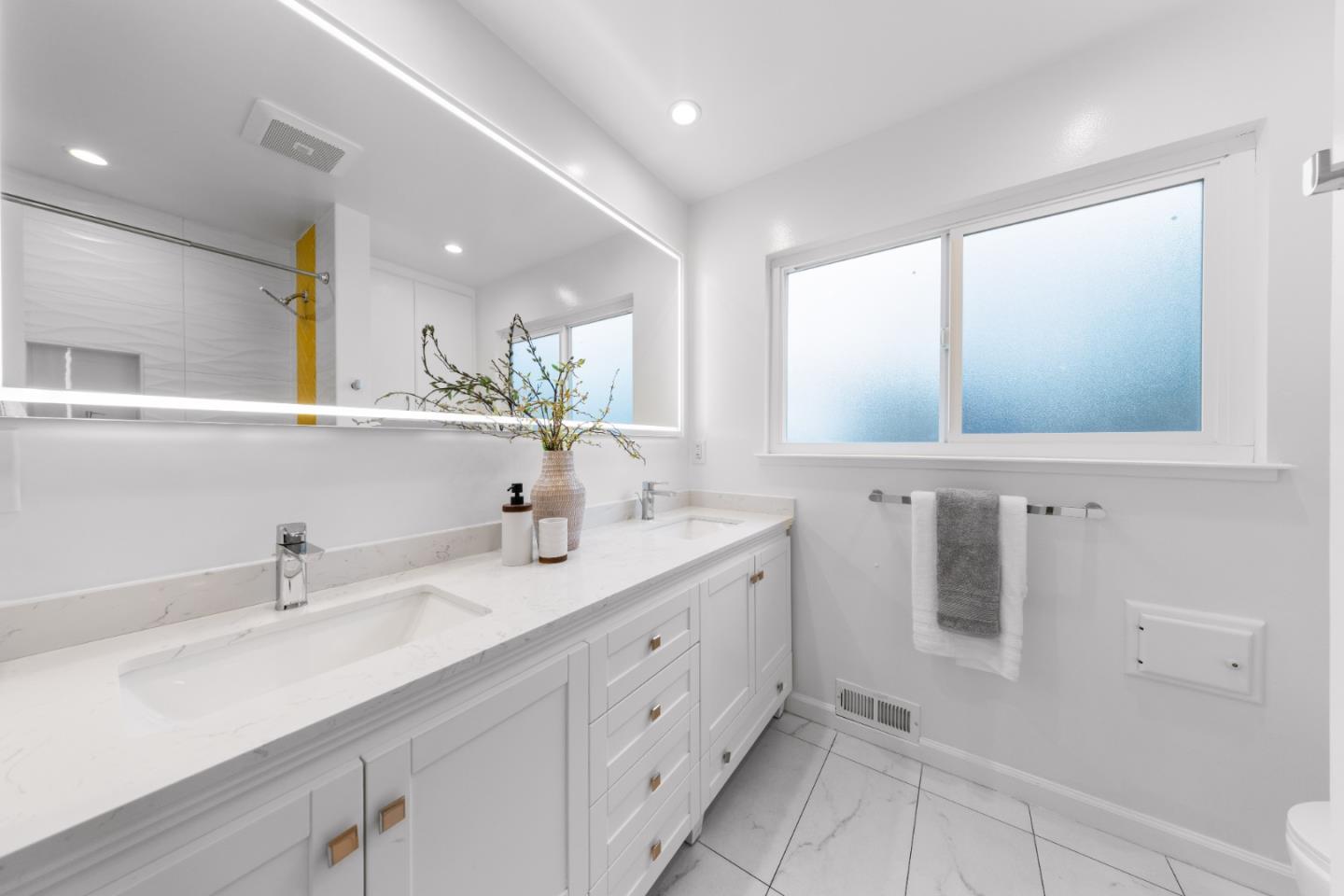 1637 Kitchener Drive Sunnyvale, CA 94087 - Photo 41 of 57 a bathroom with a double vanity sink a mirror and a bathtub