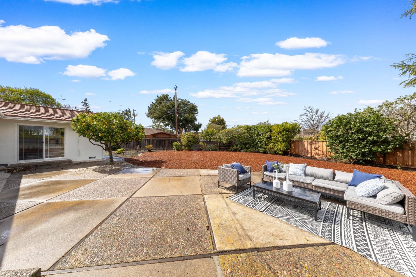 1637 Kitchener Drive Sunnyvale, CA 94087 - Photo 46 of 57 a view of a patio with couches and table and chairs with wooden floor and fence