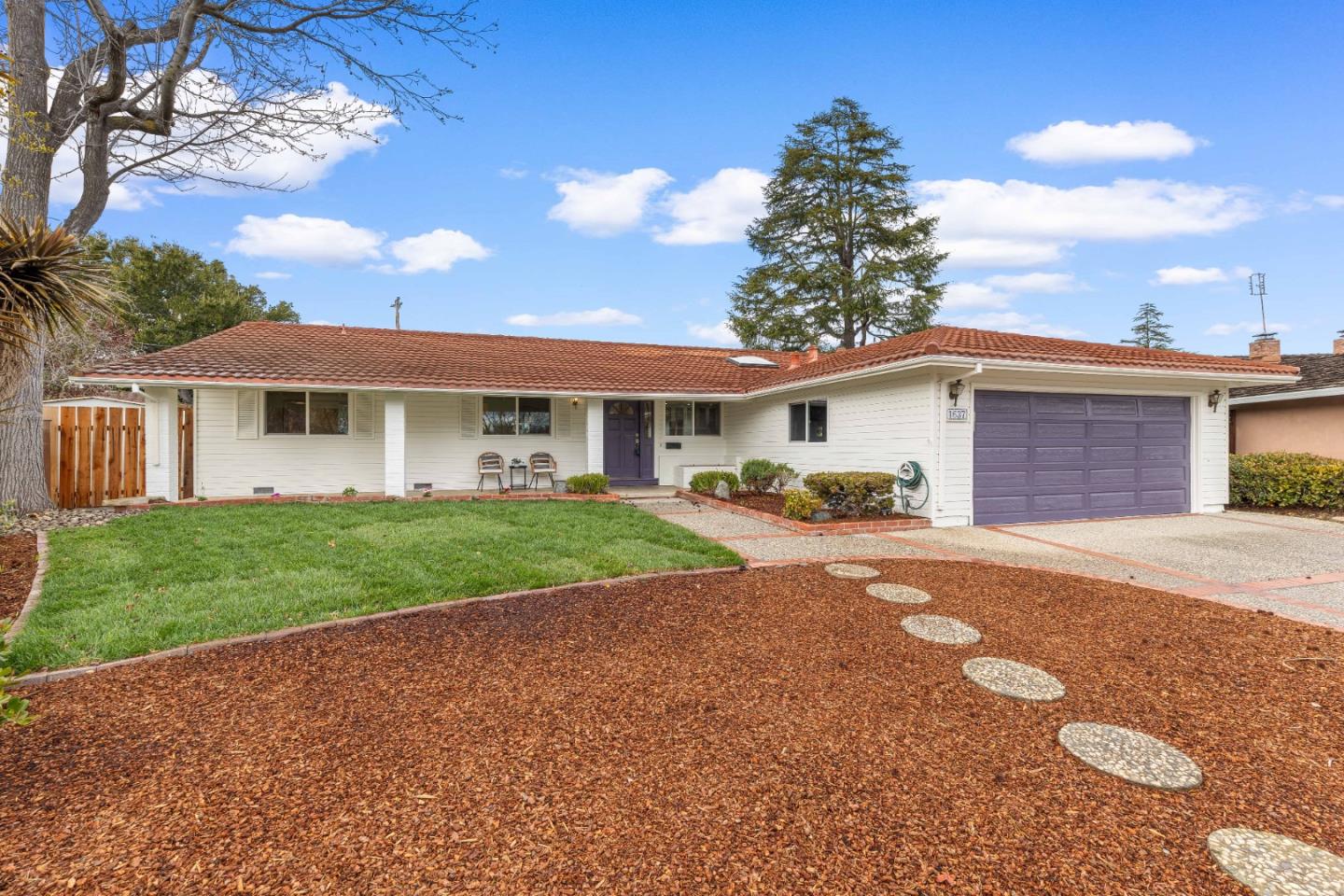 1637 Kitchener Drive Sunnyvale, CA 94087 - Photo 5 of 57 a front view of a house with a yard and garage